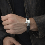 Masculine man wearing luxury black paracord bracelet with sterling silver shackle